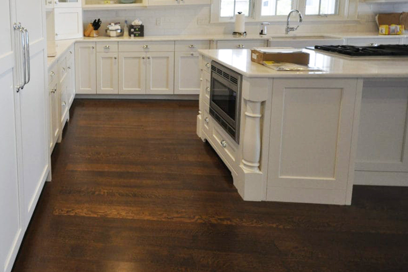 Dark floor with light kitchen cabinets